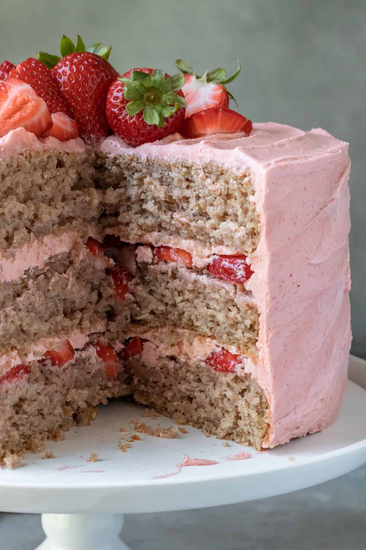 close up photo showing natural color of strawberry cake and layers of frosting.