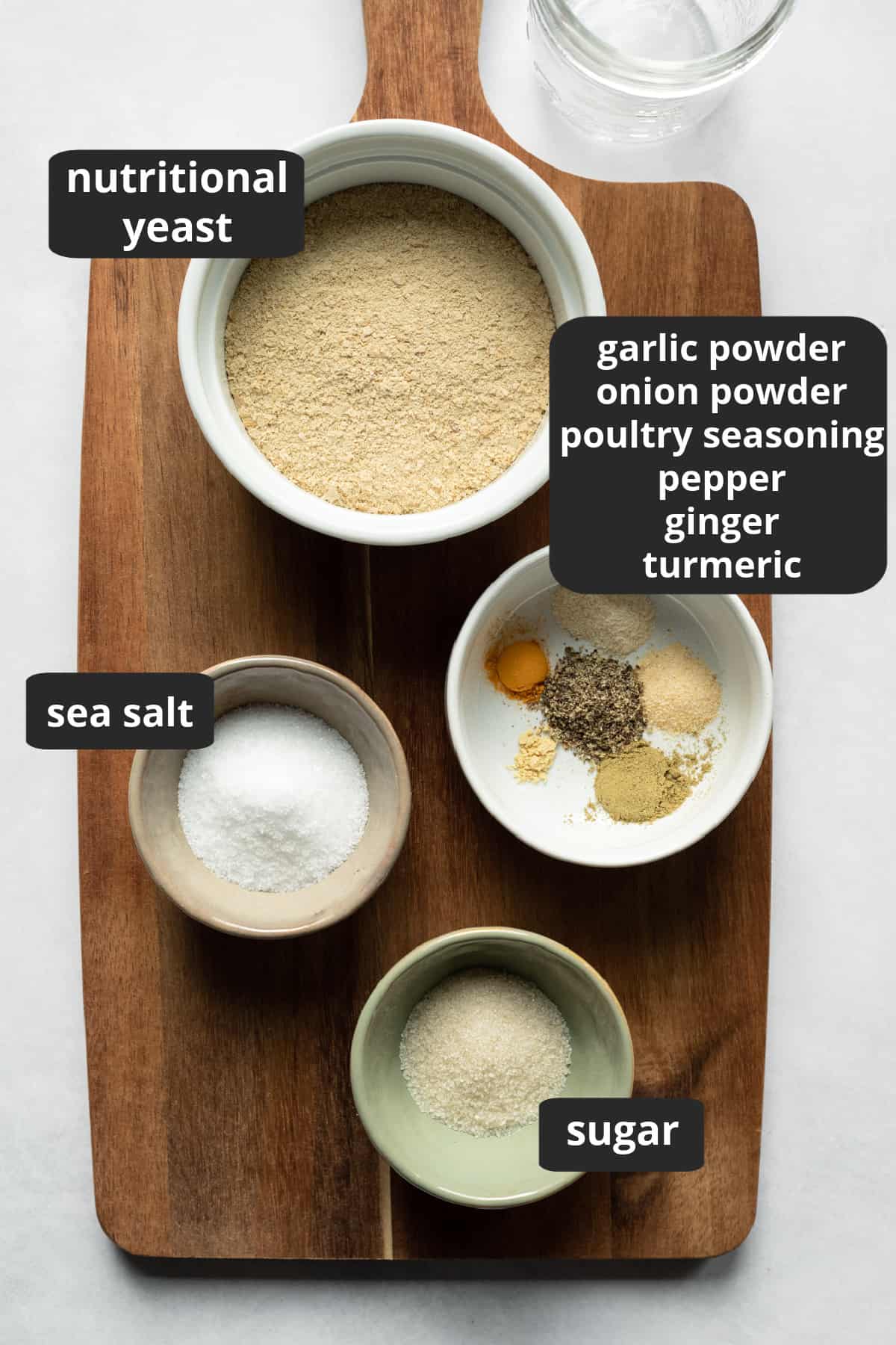 labeled photo of vegan chicken bouillon ingredients laid out on a wooden board.