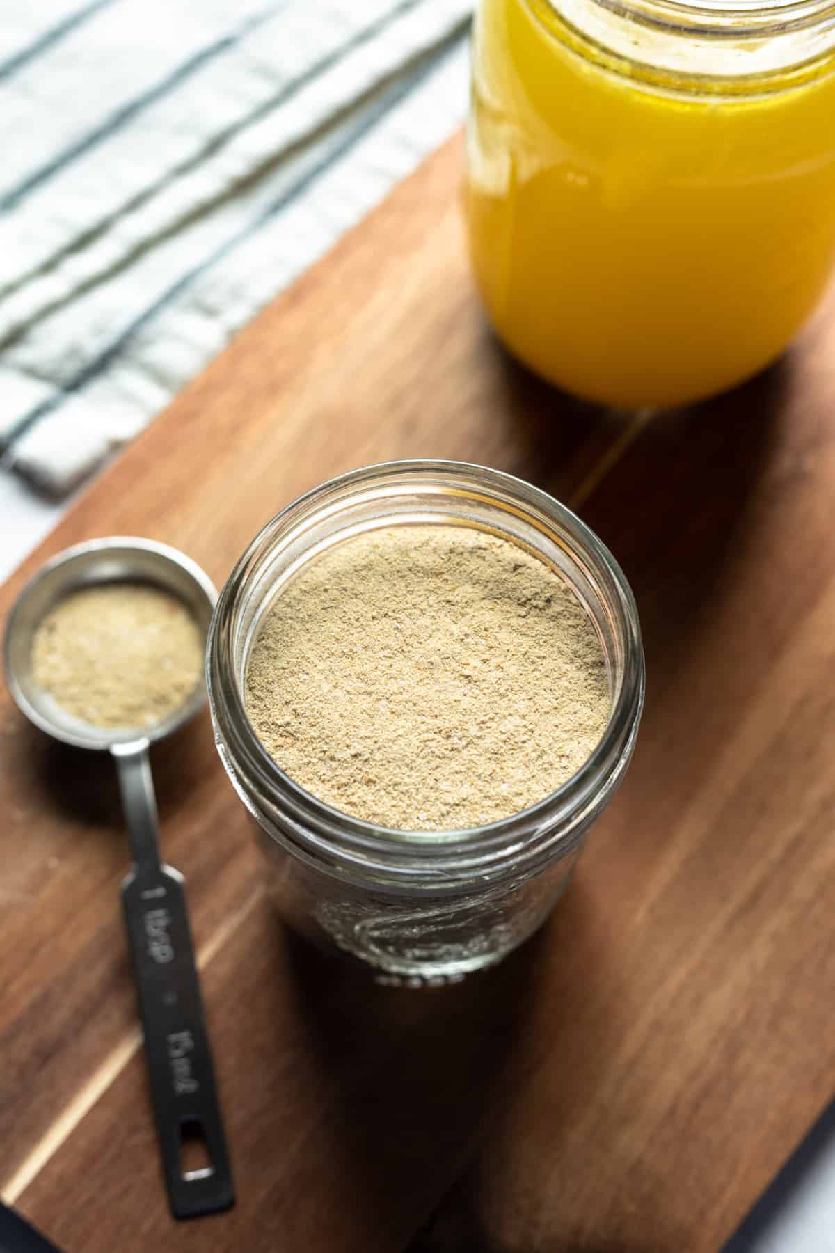 looking down into jar of nutritional yeast-based vegan chicken broth powder.