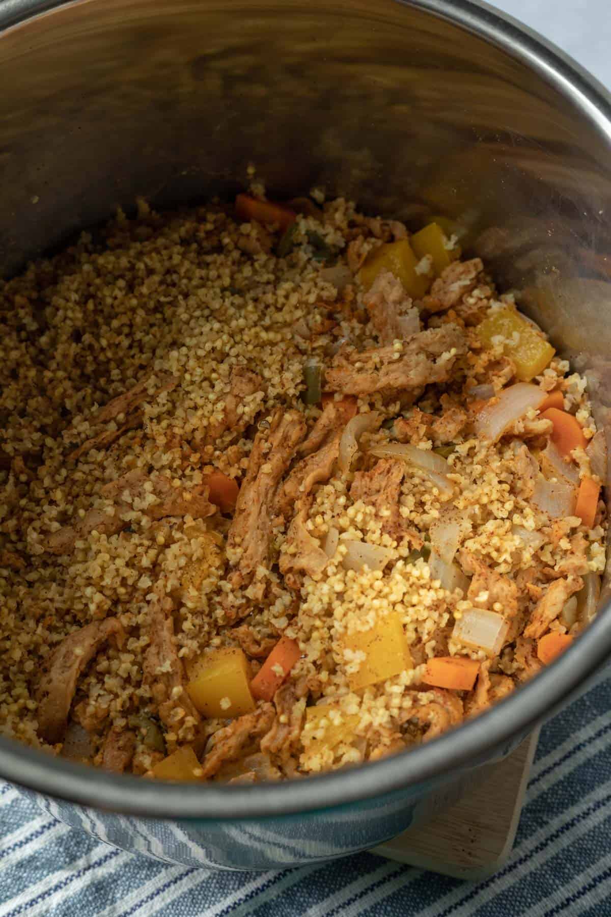 showing texture of millet and soy curls inside Instant Pot after removing lid.