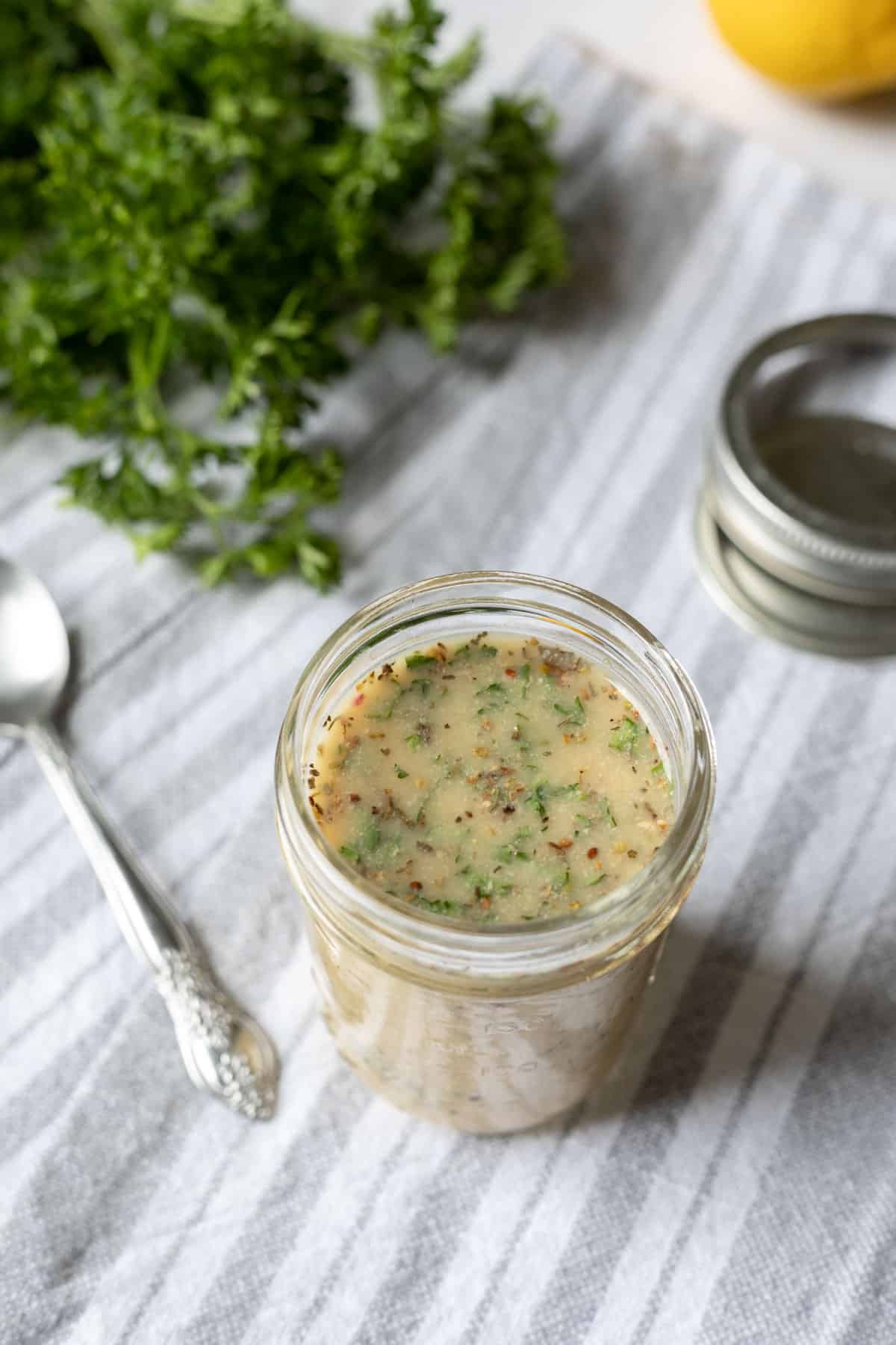 Fat free Italian salad dressing in a small glass jar.