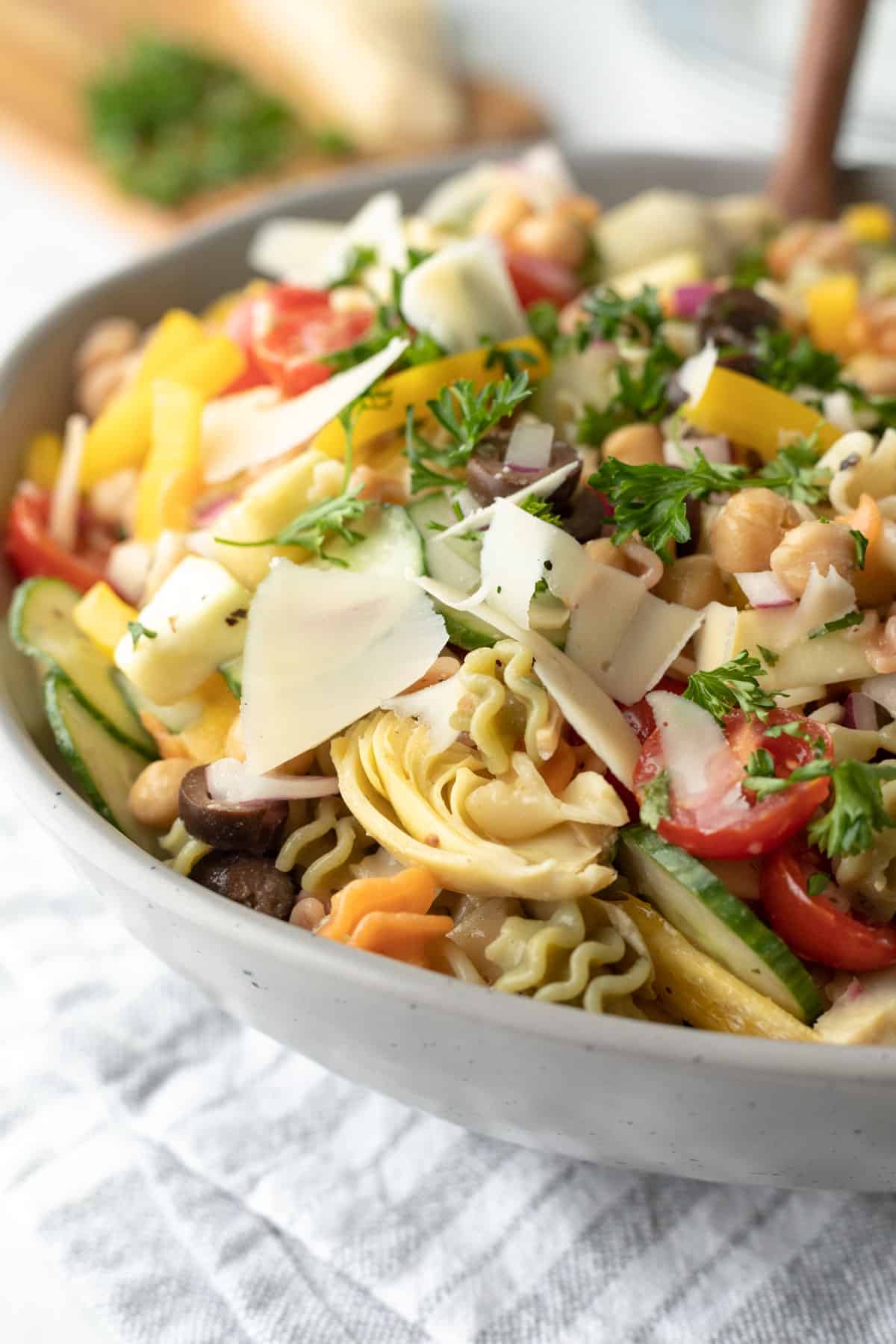 close up view of pasta salad with artichokes, cucumber, chickpeas, onion, zucchini.