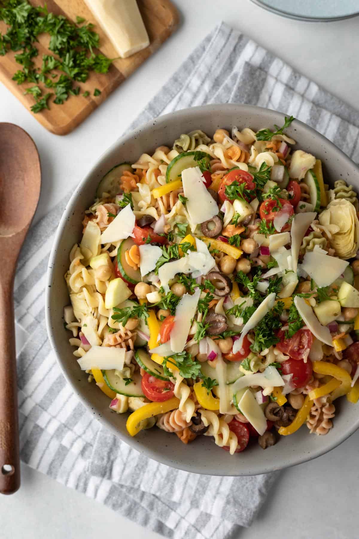large gray serving bowl filled with colorful veggies and pasta salad.