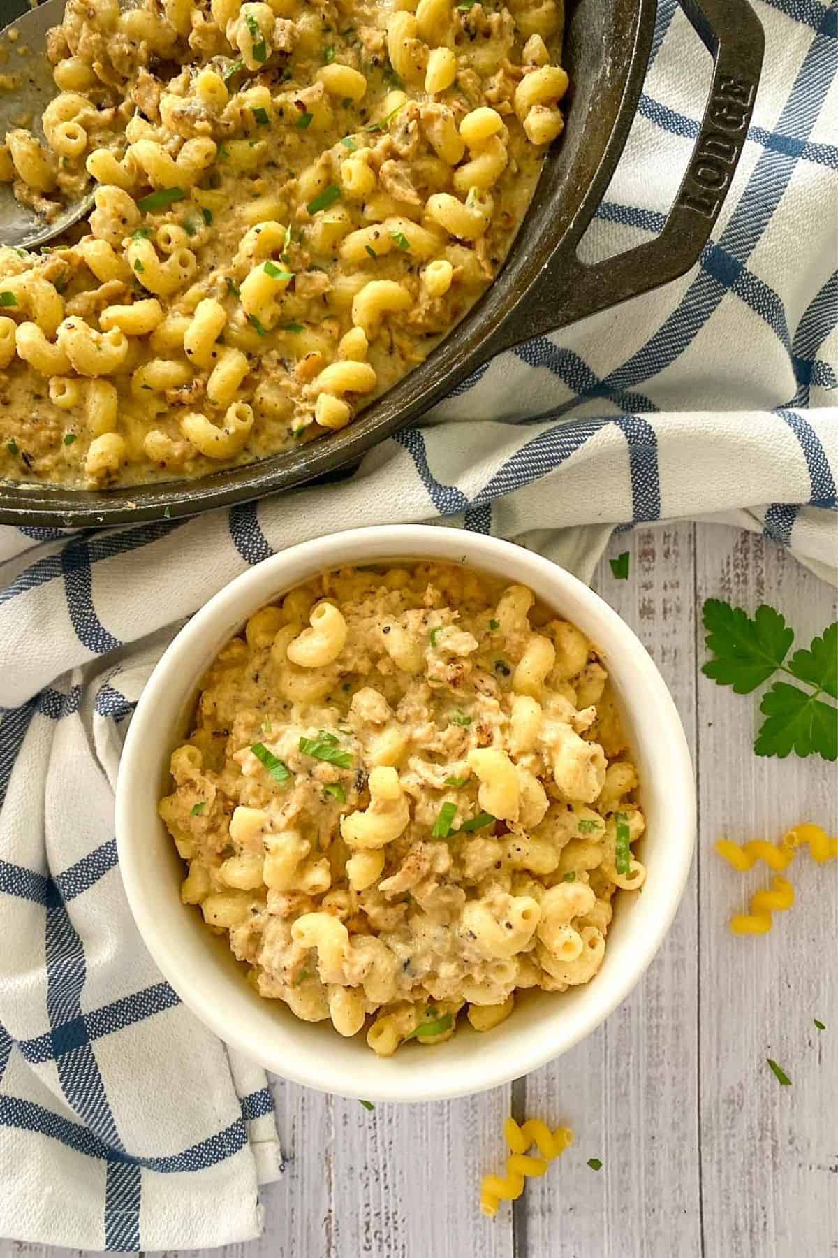 overhead view of a pot and bowl full of creamy vegan hamburger helper.