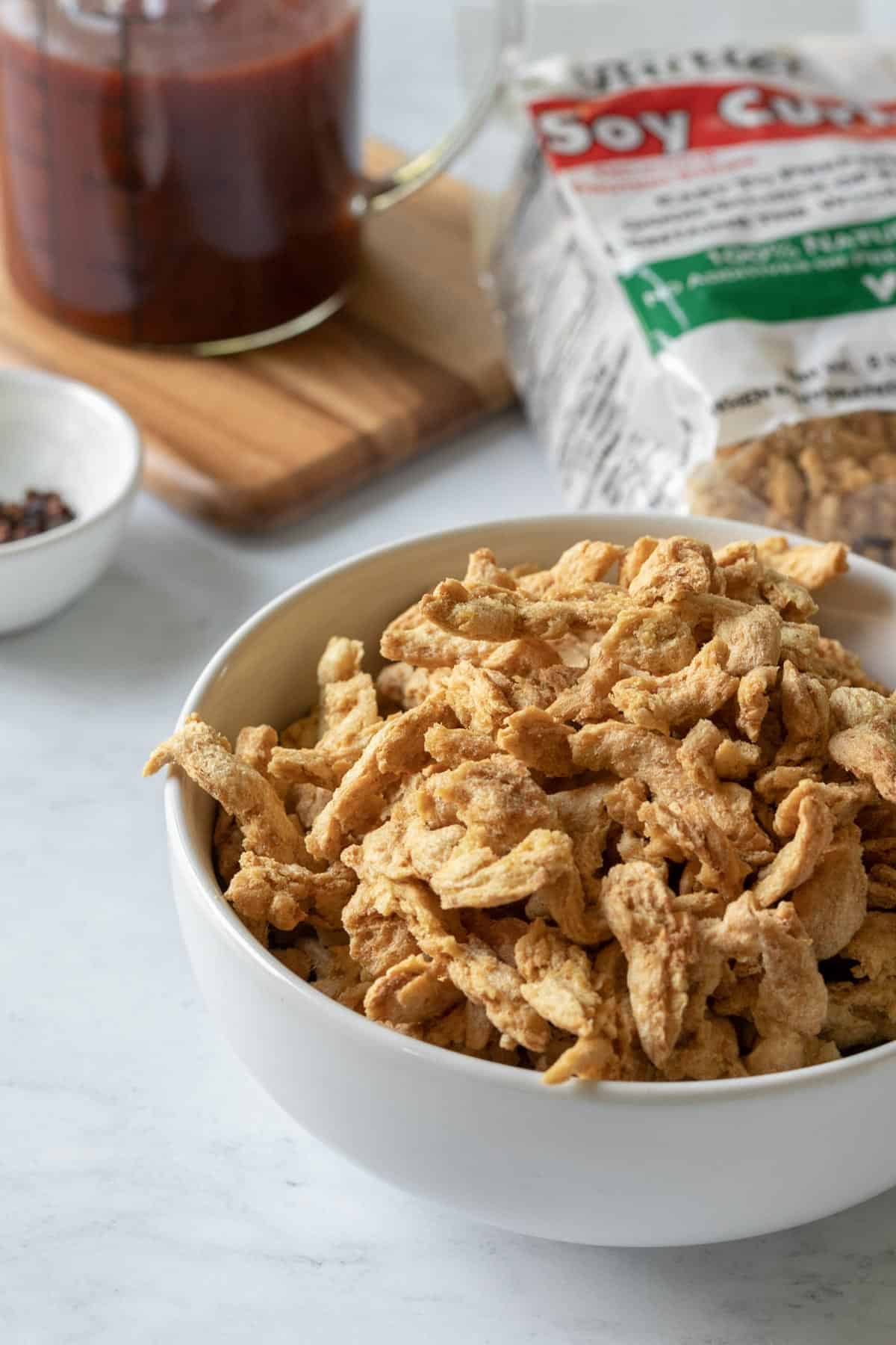 dry soy curls in a small white bowl.