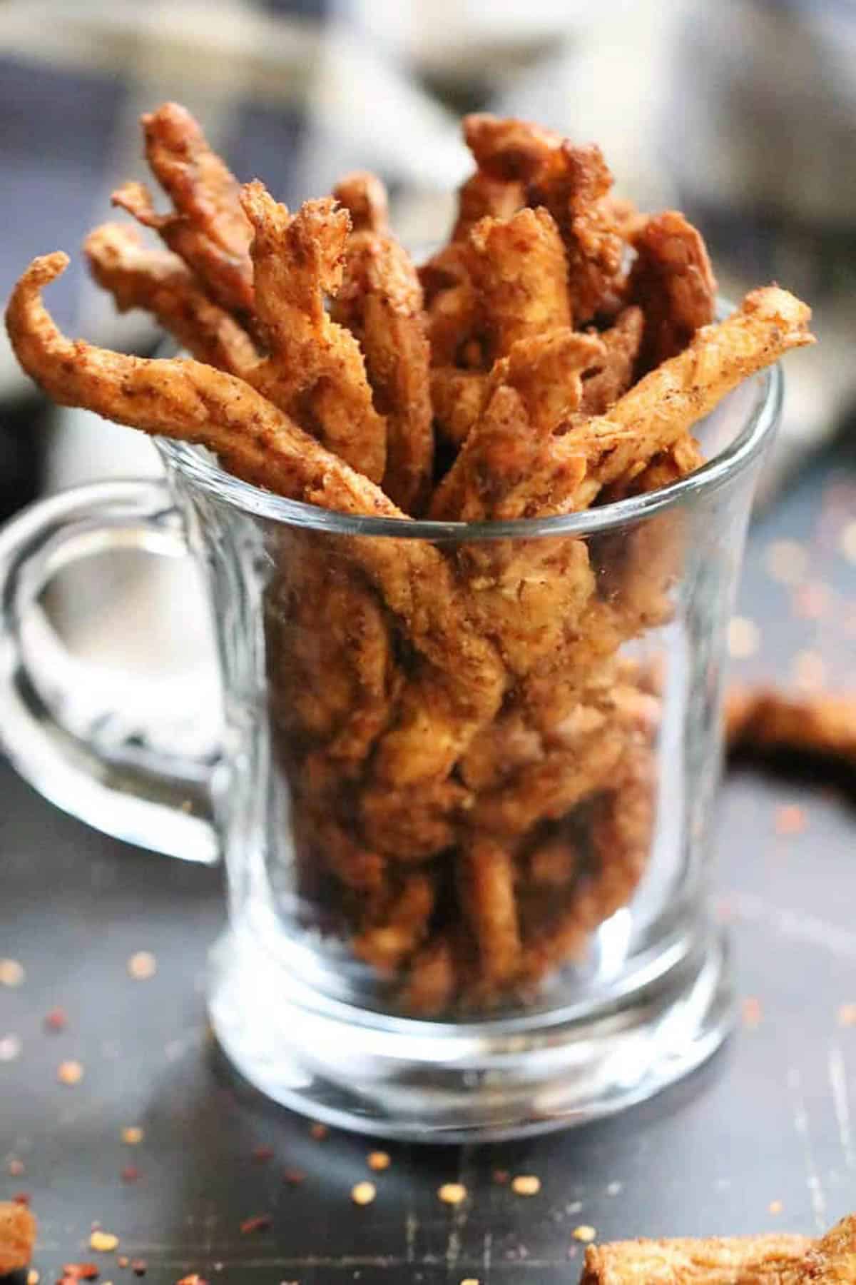 plant based soy jerky packed in a glass mug.