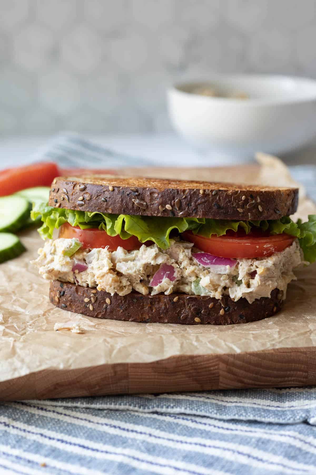 a sandwich with whole-grain bread, creamy "chicken" salad, lettuce and tomato.