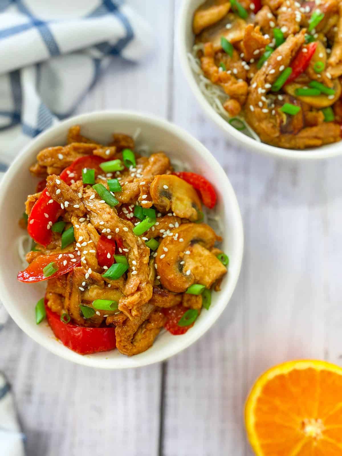 overhead shot of colorful soy curl chicken and peppers in white bowls.