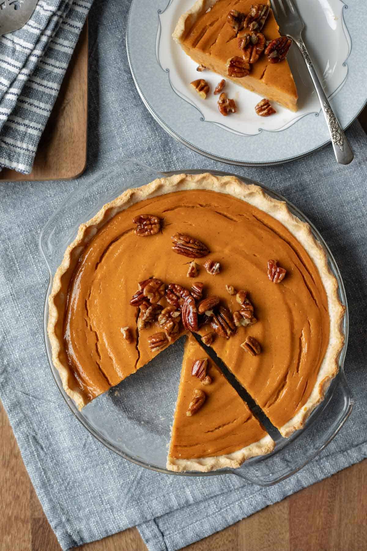 Overhead shot of vegan sweet potato pie with a slice taken out and put on a plate next to it.