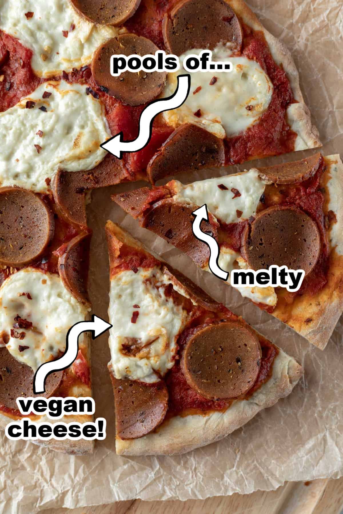 vegan pepperoni pizza on cutting board with text overlay pointing to melted cheese.