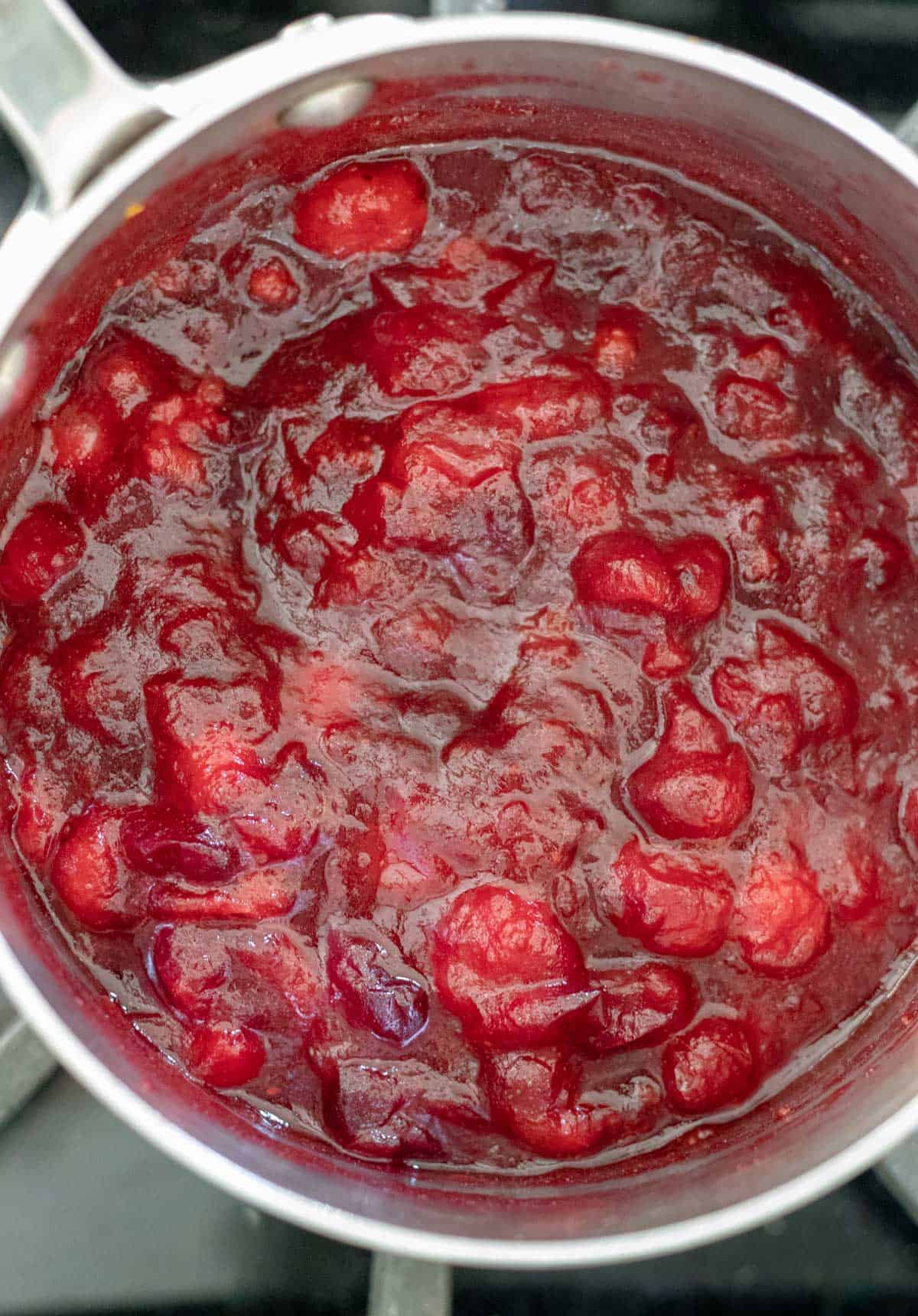 overhead view of thick cranberry sauce in small sauce pan.