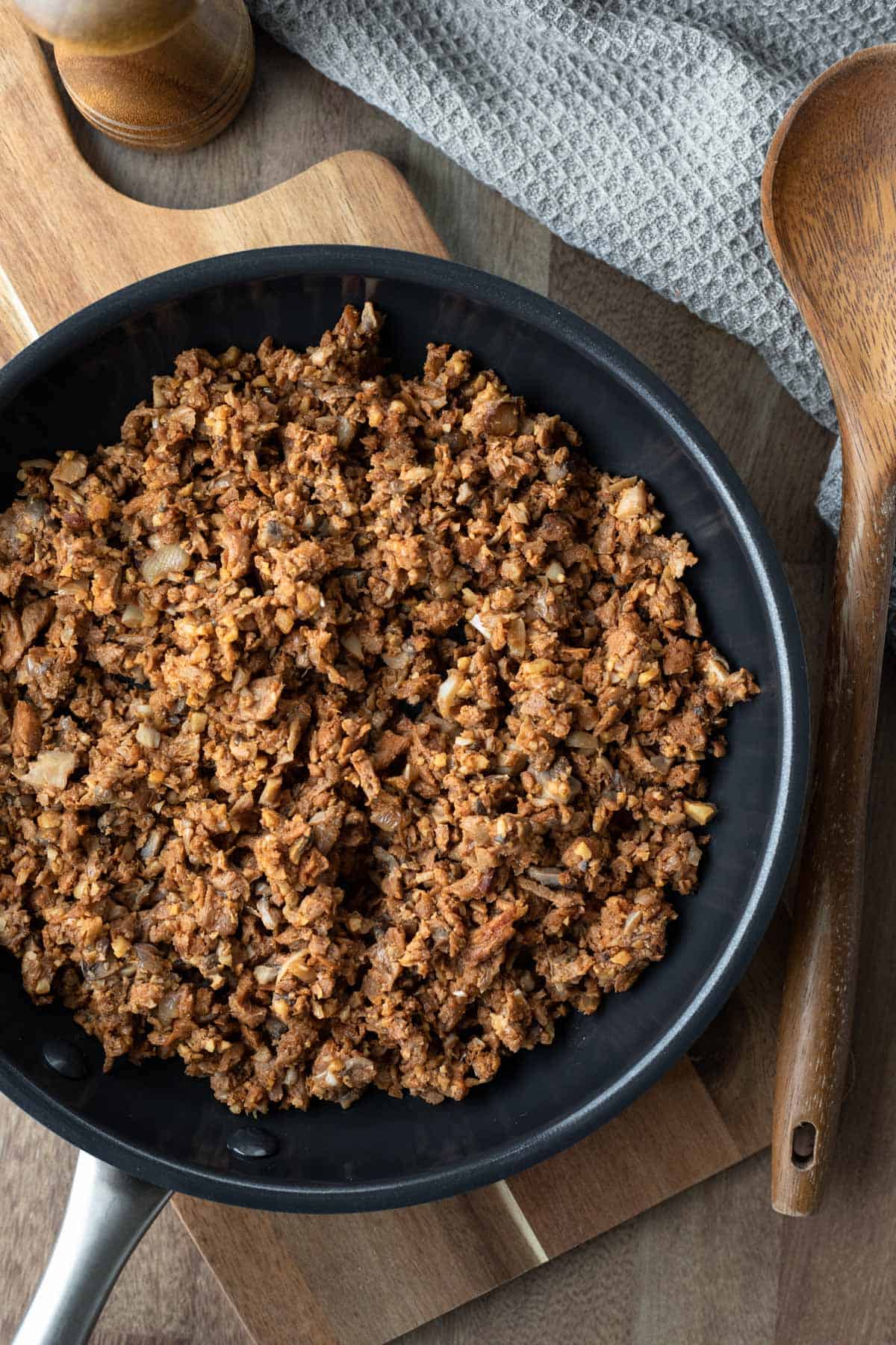 meaty vegan beef substitute with mushrooms, soy curls, and walnuts in a pan.