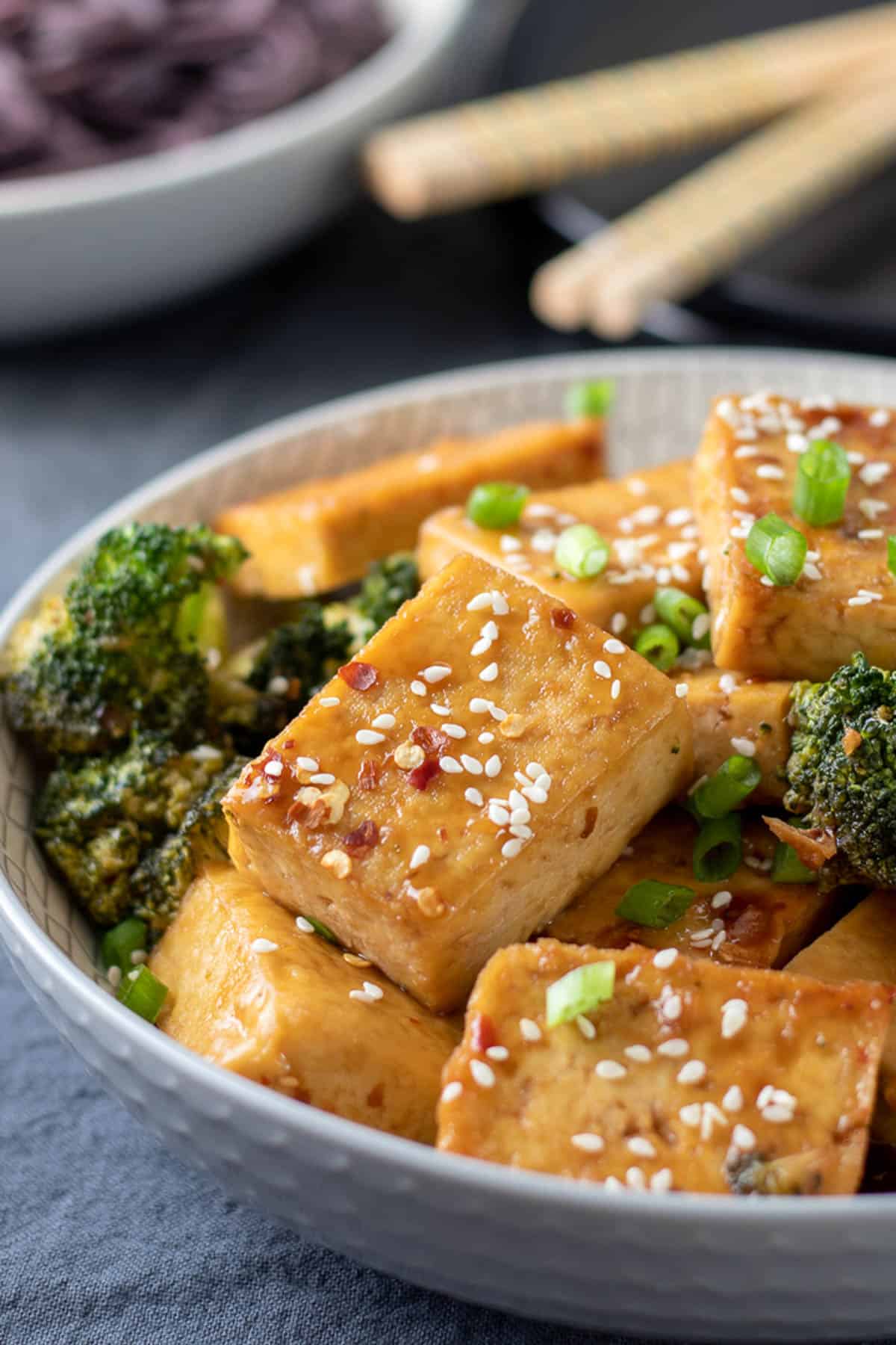 close up photo of tofu and broccoli in a serving bowl.