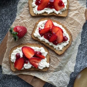 toasted bread topped with vegan tofu cottage cheese and strawberries.