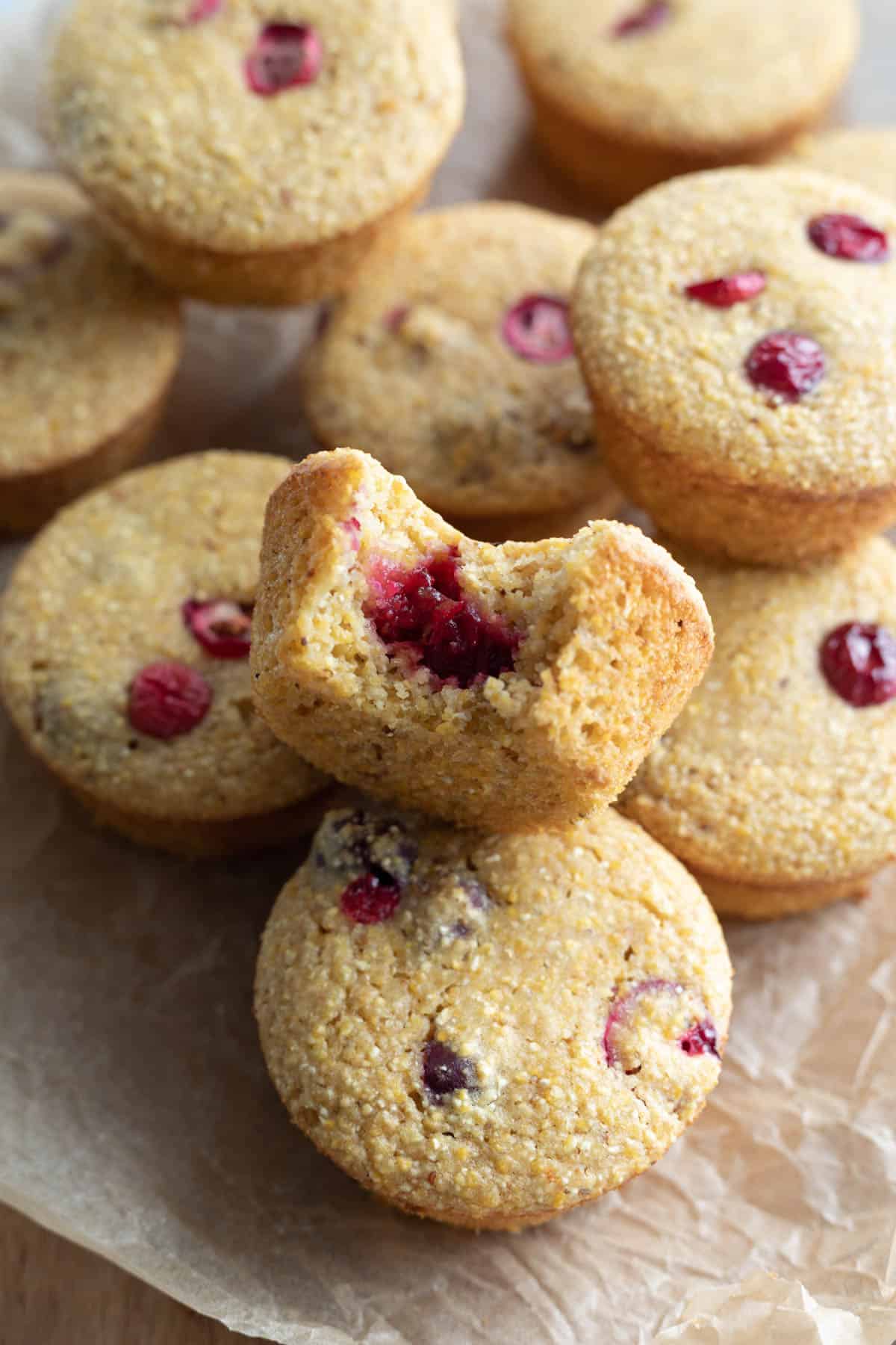 close up of vegan cranberry corn muffins on a serving board.