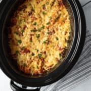 looking down inside crock pot full of cheesy vegan lasagna