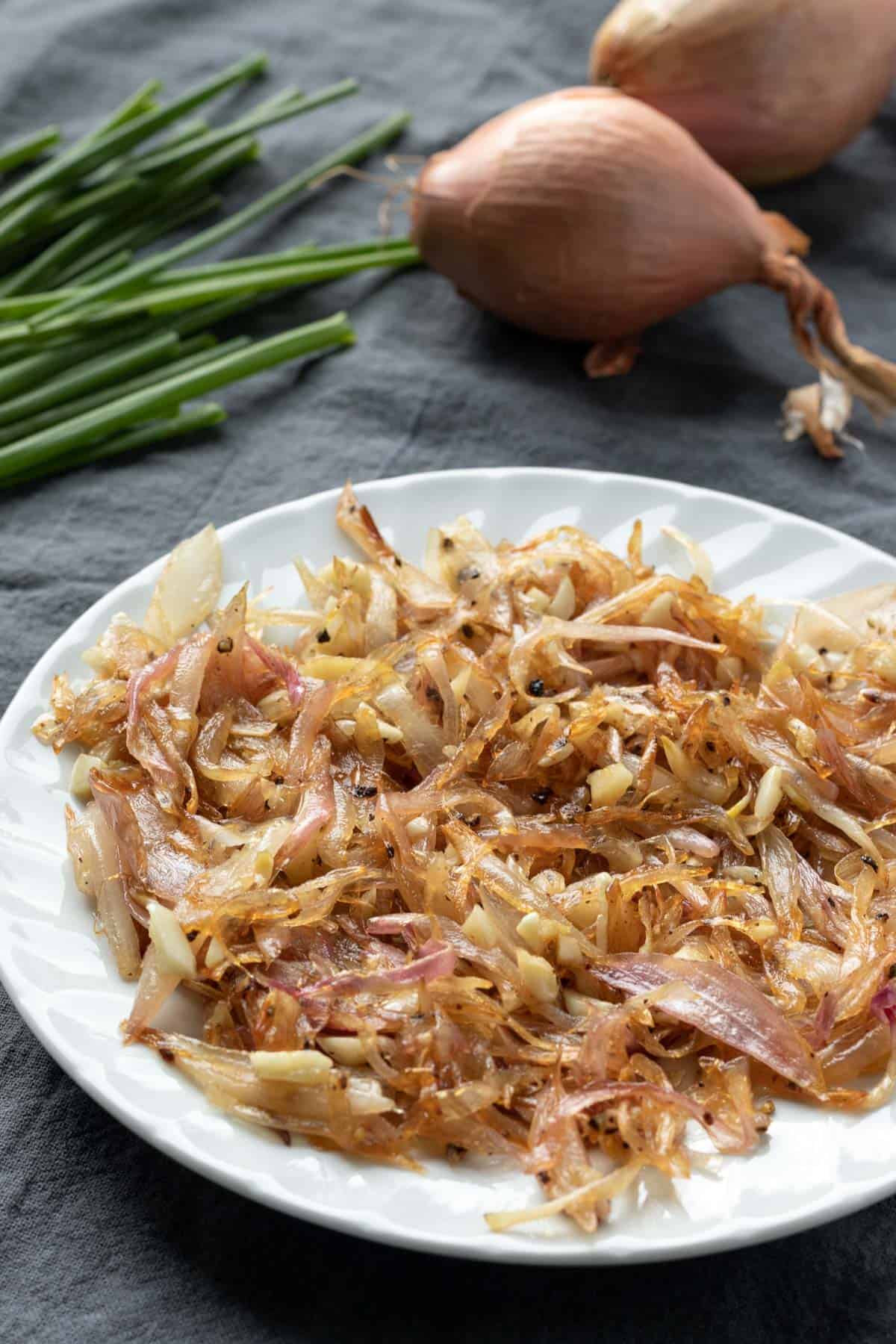 Tender, caramelized shallot and onion cooling on a plate.
