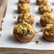 baked stuffed mushrooms on a baking sheet.