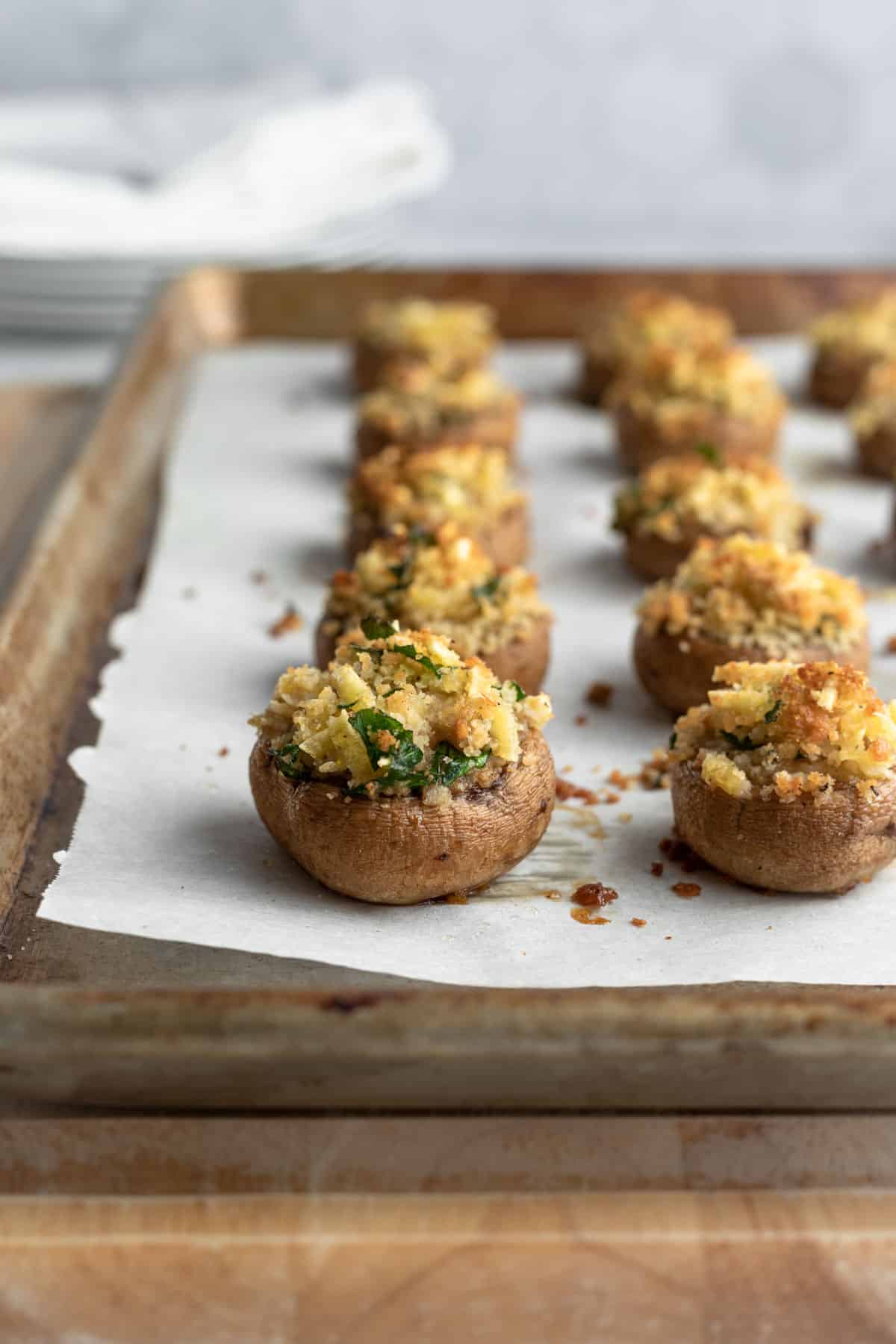 fresh from the oven stuffed mushrooms on a baking sheet.