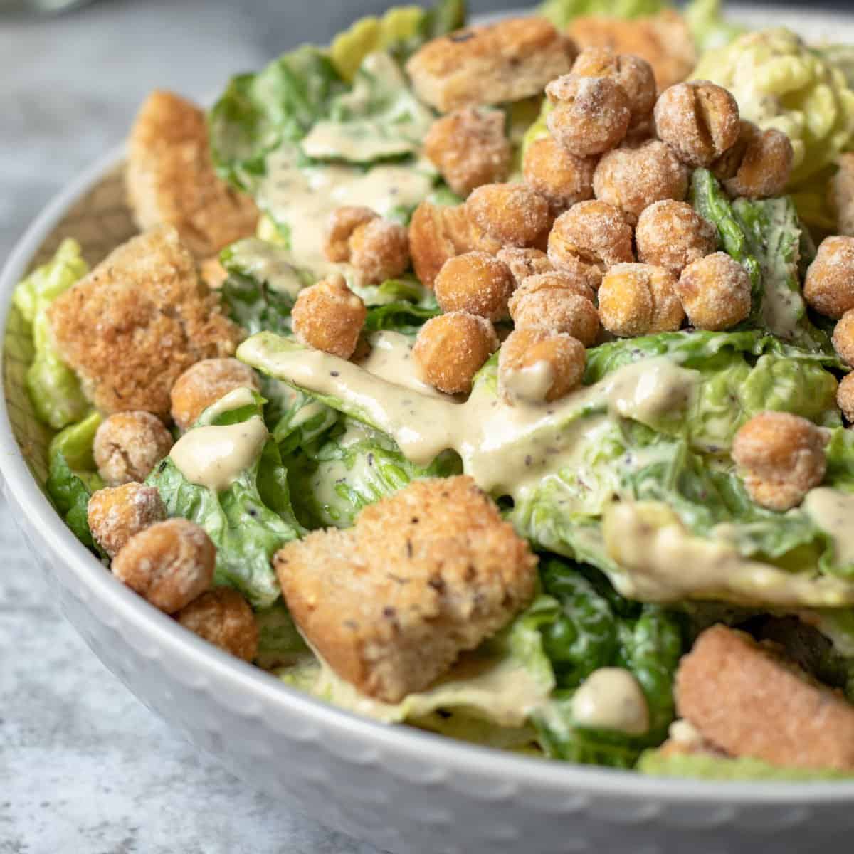 close up photo of romaine dressed with a creamy oil-free Caesar.