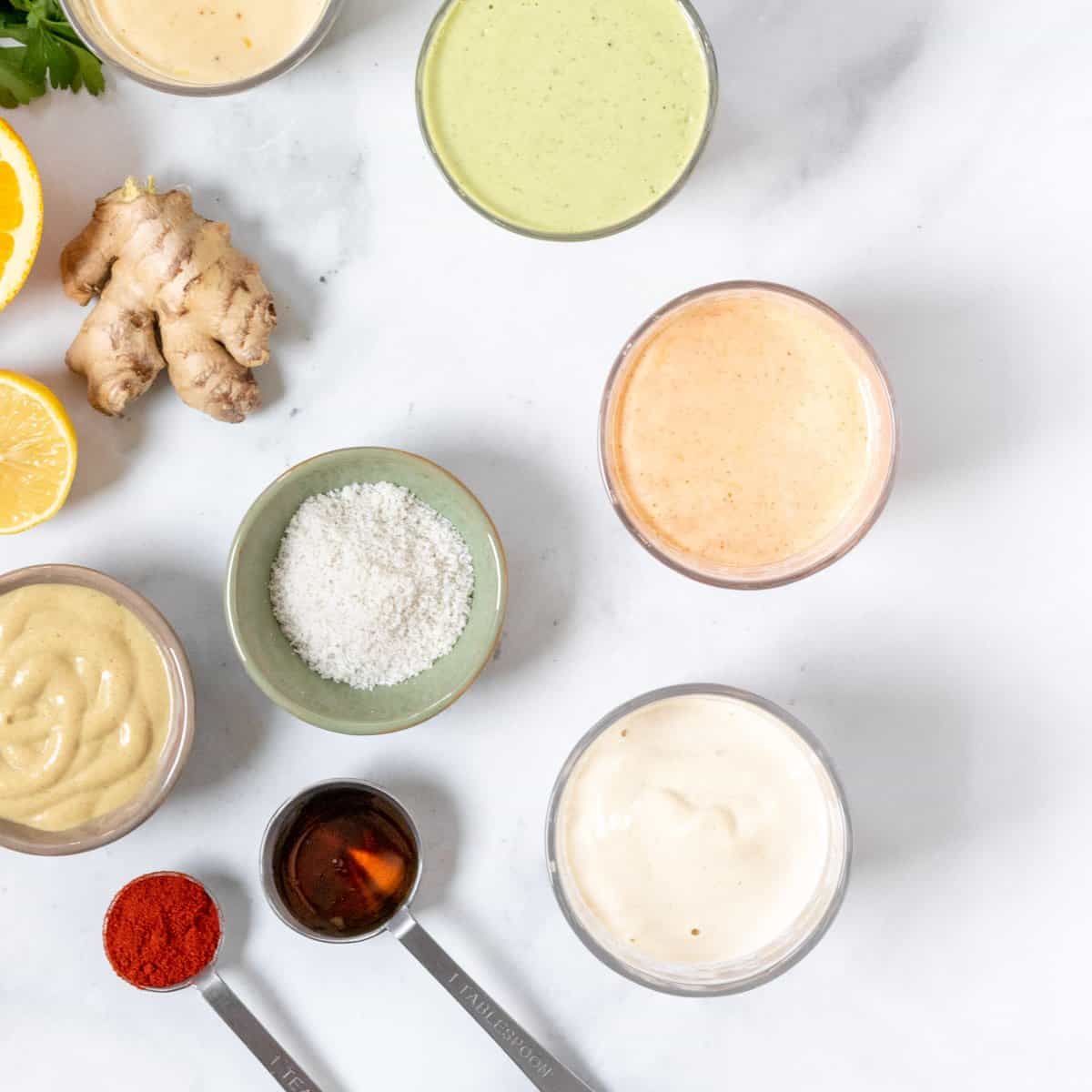 photo of 4 different colorful salad dressings made with tahini.