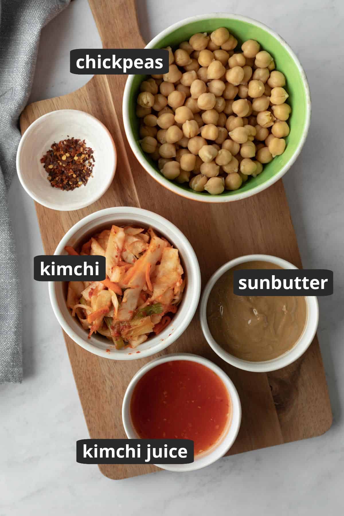 labeled photo of the ingredients needed for spicy kimchi hummus.