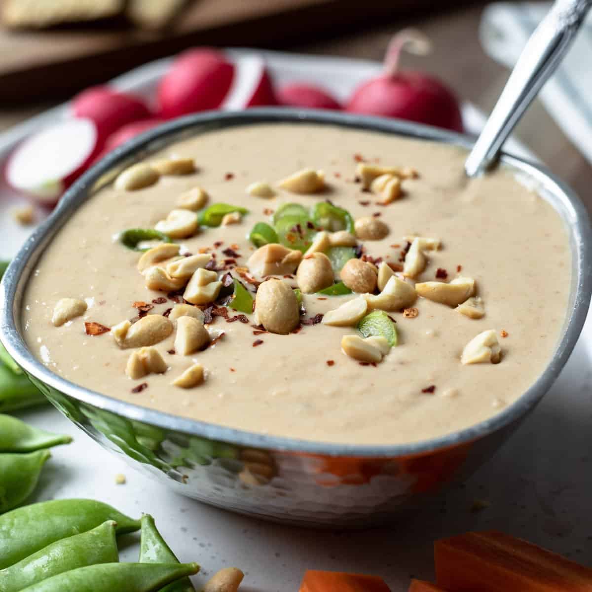 creamy white bean dressing garnished with green onion and peanuts.