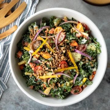 overhead photo of colorful vegan kale salad in a large bowl.