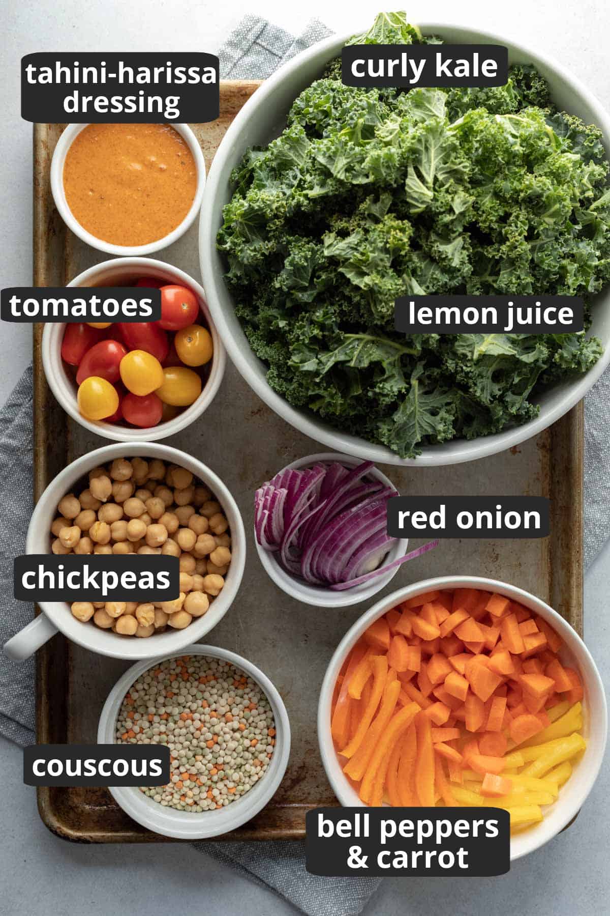 labeled photo showing the ingredients needed for kale salad with couscous and chickpeas.
