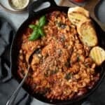 white bean and tomato skillet pasta bake with crusty bread and fresh basil.