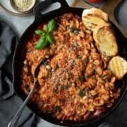white bean and tomato skillet pasta bake with crusty bread and fresh basil.