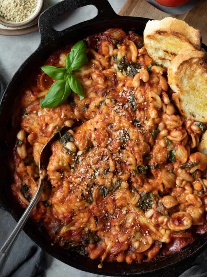 white bean and tomato skillet pasta bake with crusty bread and fresh basil.