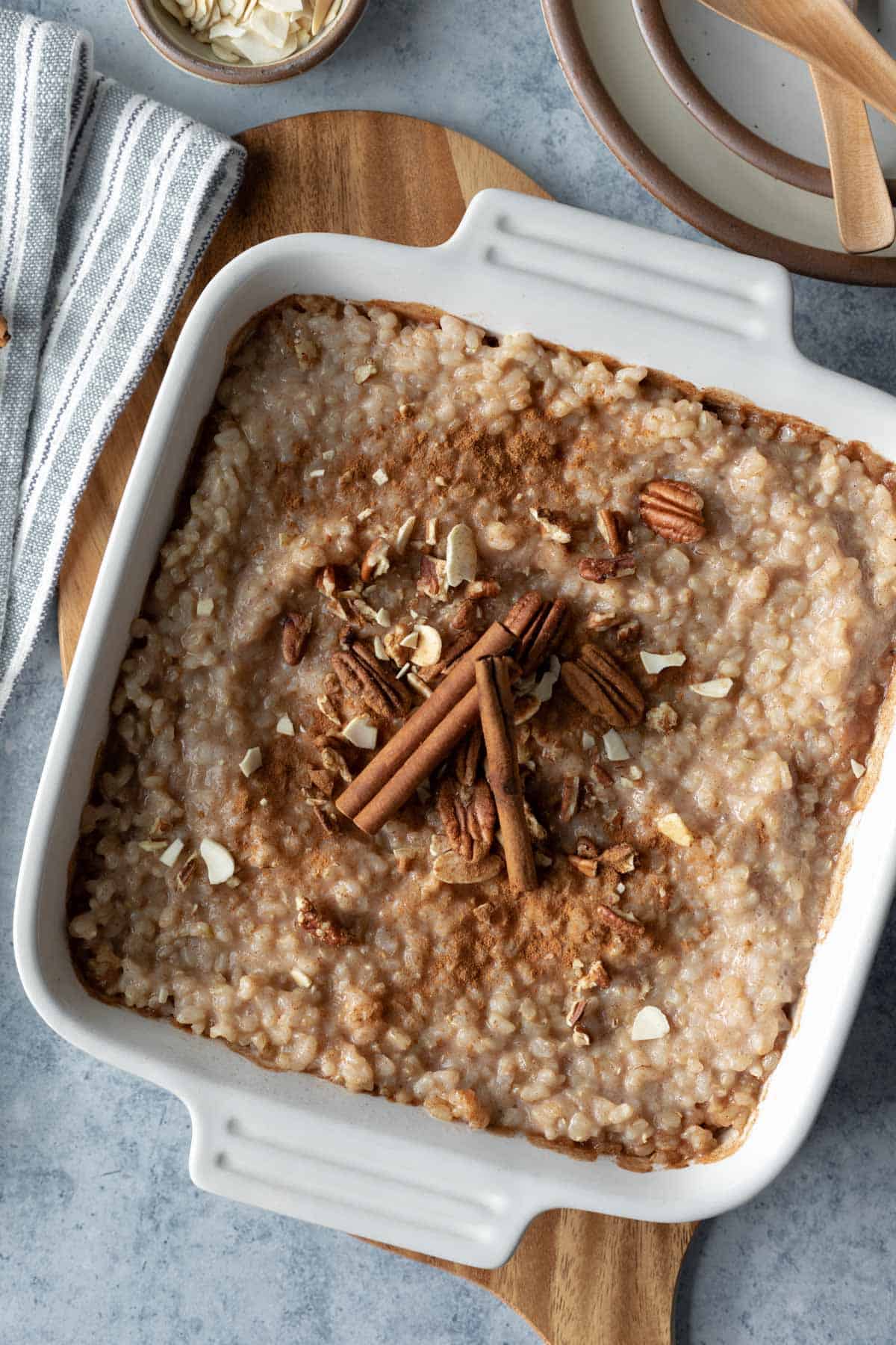overhead photo of brown rice pudding in a square white baking dish.