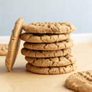 a stack of vegan peanut butter cookies on parchment paper.