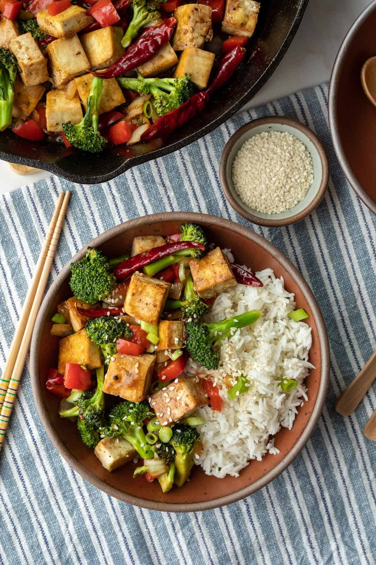 skillet filled with Szechuan tofu and a serving in a bowl.
