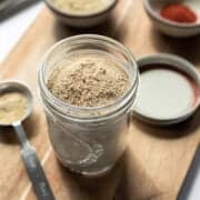 a glass jar filled with homemade beef flavored broth powder.
