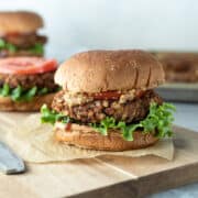 close up of jackfruit veggie burger on a bun with toppings.