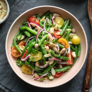 Italian green bean salad with tomatoes in a serving bowl.