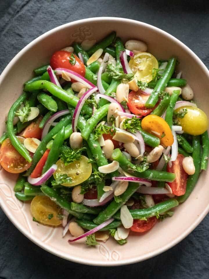 Italian green bean salad with tomatoes in a serving bowl.