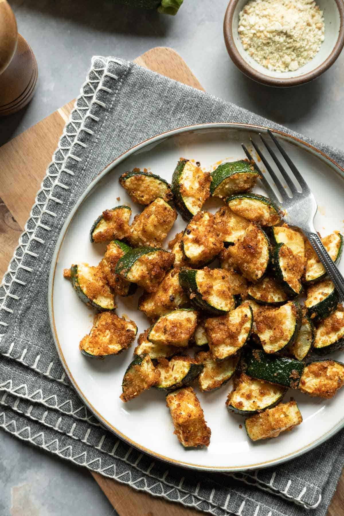 air fried zucchini with a golden panko breading on a plate.