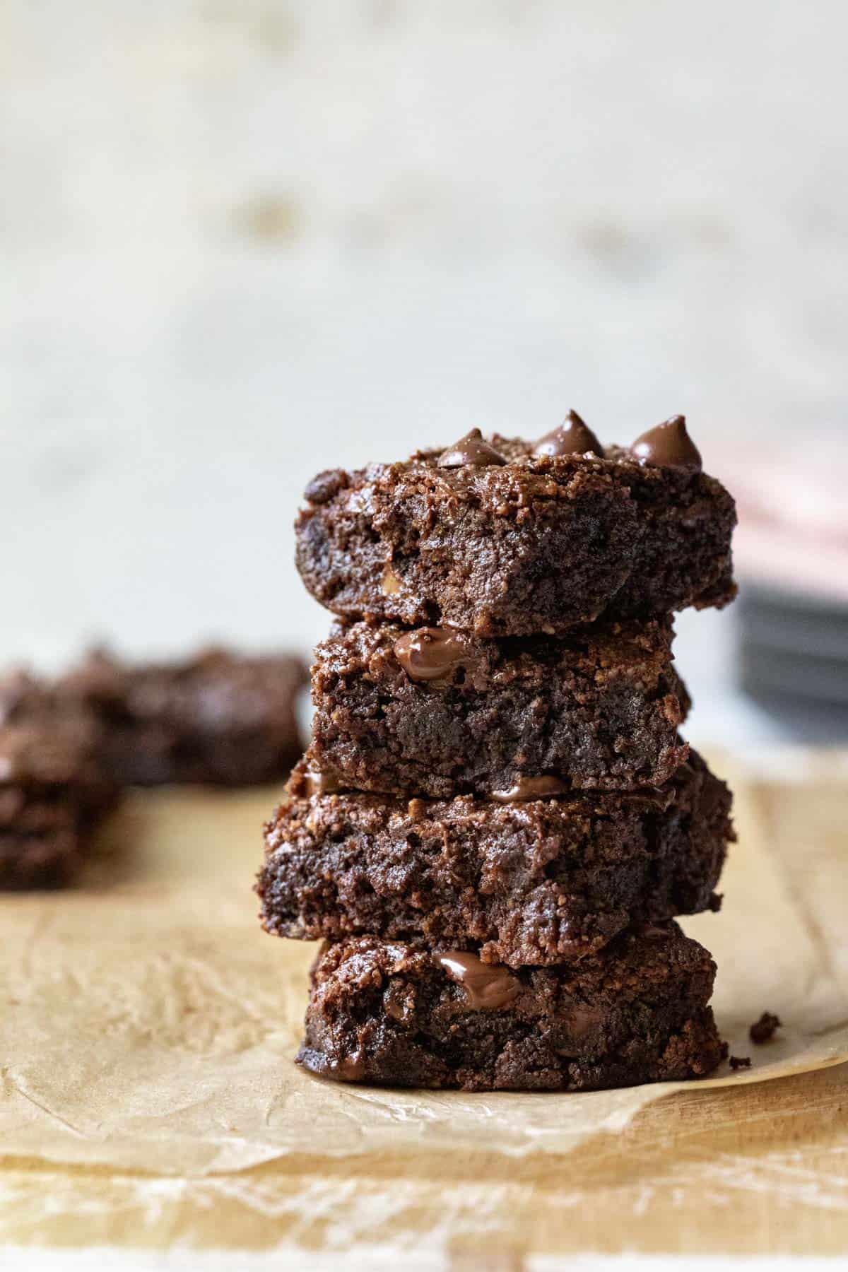 a stack of 4 dark and gooey almond flour brownies.