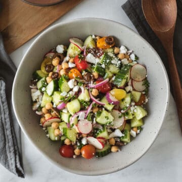 colorful cucumber salad in a large serving bowl.