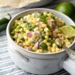 light blue bowl filled with colorful chili corn salsa.