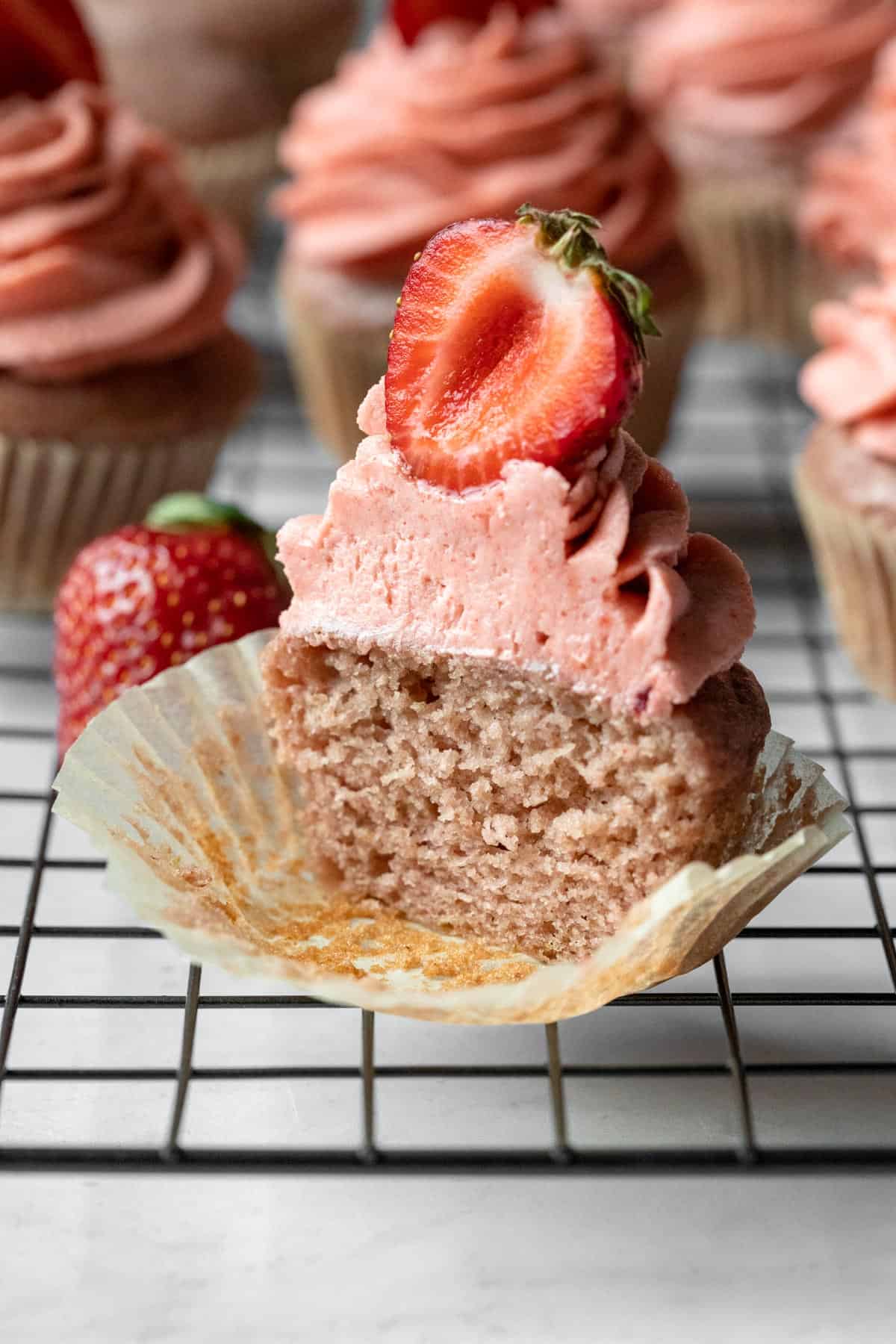 cross-section of a cupcake to show the texture of the crumb and piped frosting.