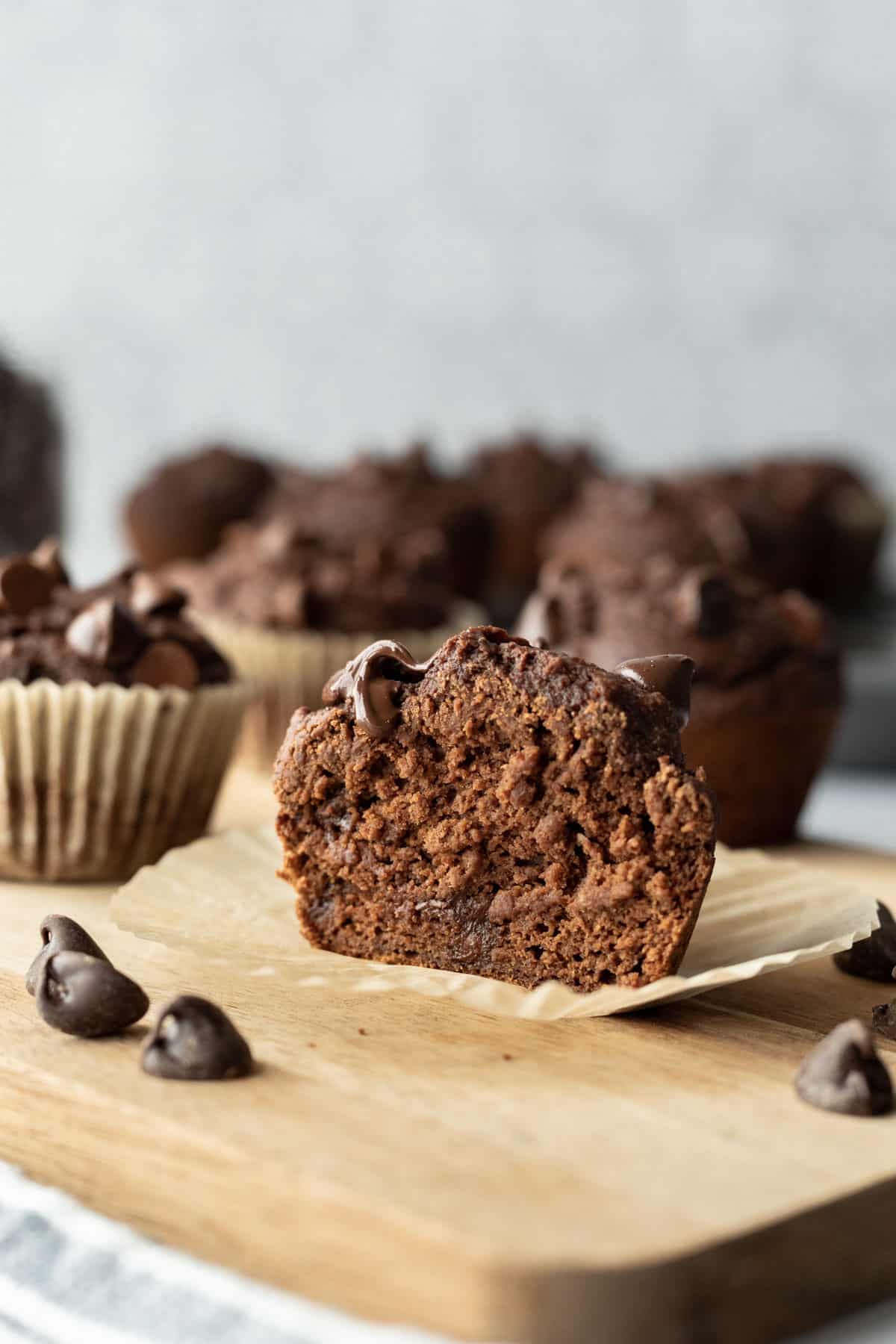 A muffin cut in half to show texture and chocolate chips inside.