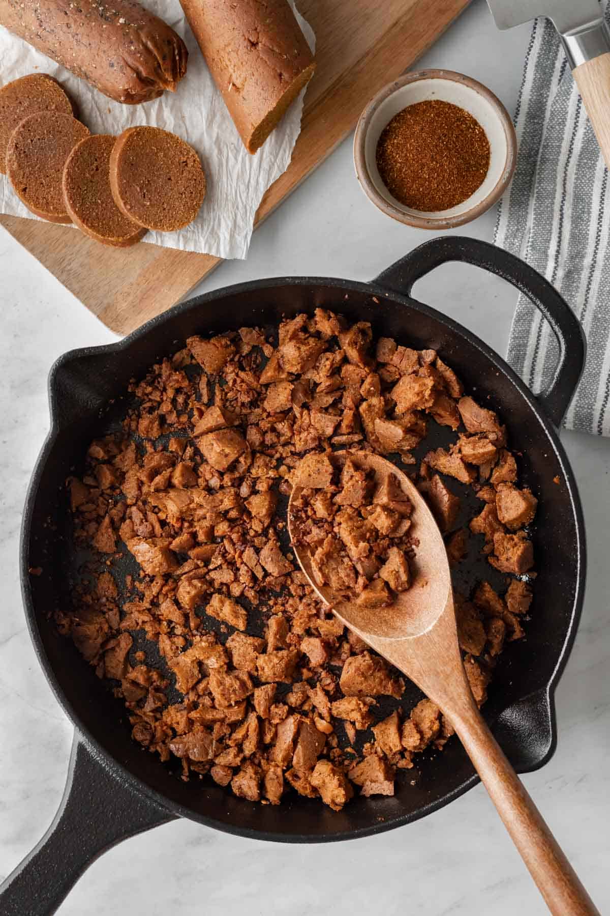 ground vegan chorizo cooking in a cast iron skillet.