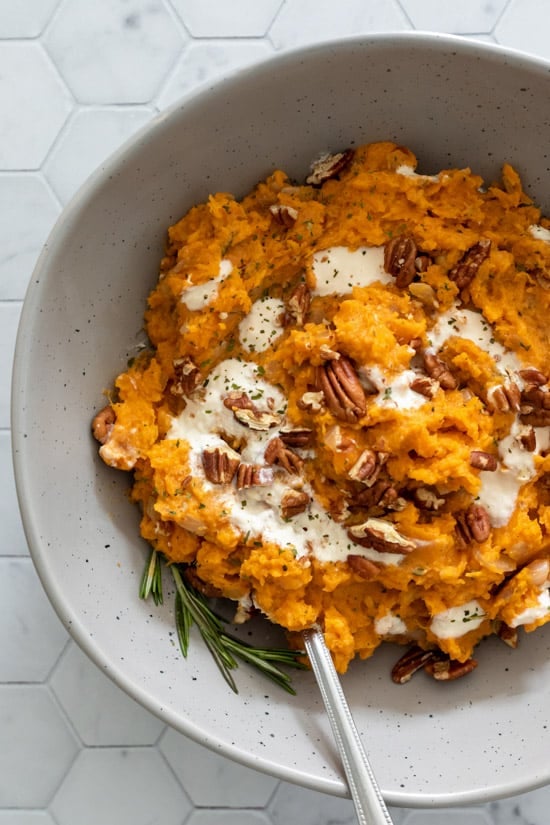 gray serving bowl filled with rosemary mashed sweet potatoes.