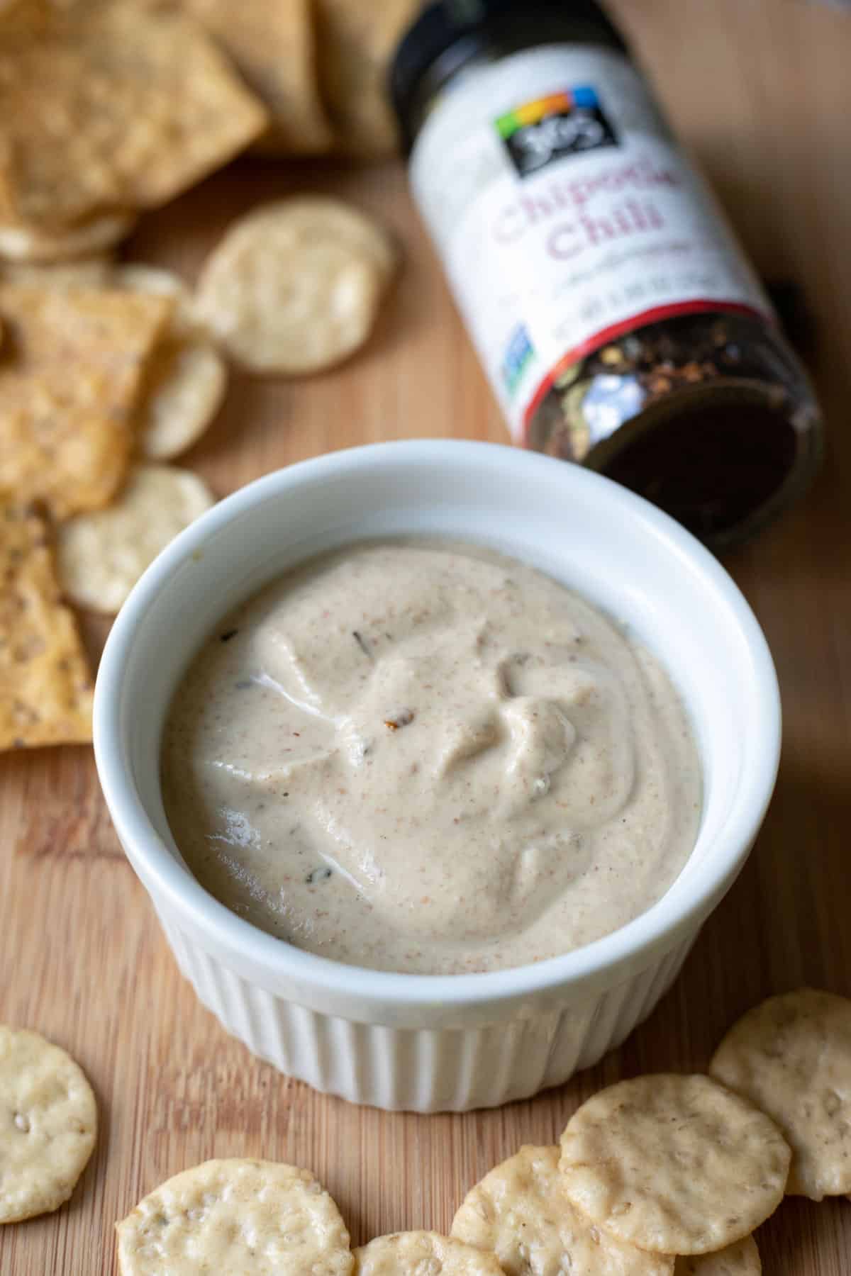 a ramekin filled with homemade chipotle almond sauce, a copycat of Bitchin Sauce's chipotle flavor.