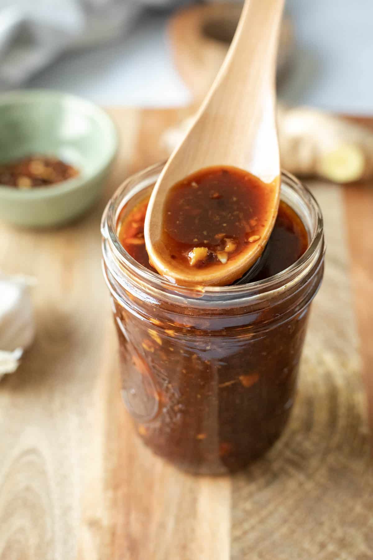 small wooden spoon over a jar of homemade Korean barbecue sauce.