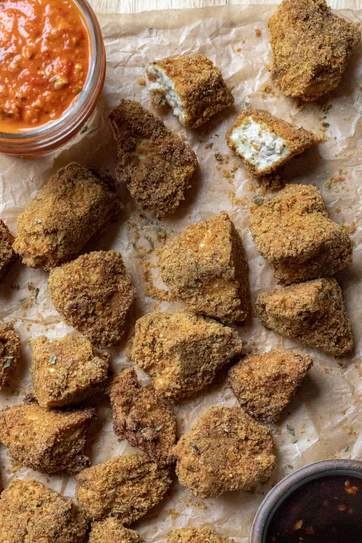breaded nuggets on a board with one torn in half to show texture of tofu.